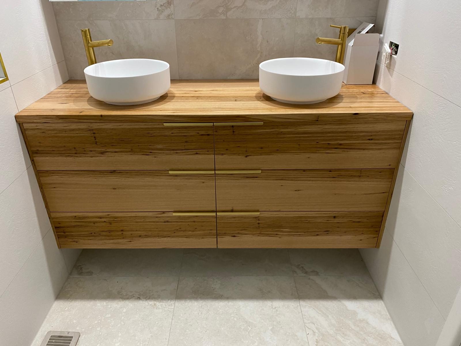 Bathroom with twin basins on a floating oak vanity unit